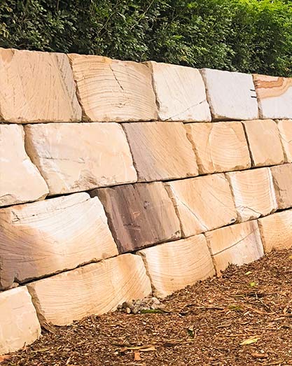 Sandstone block retaining wall and kids play area