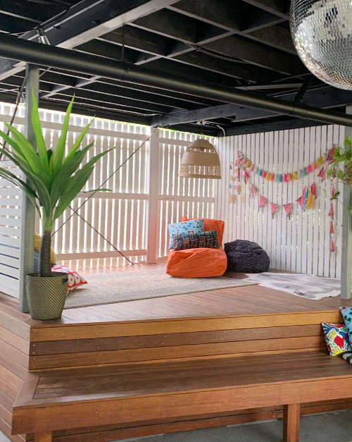 Under house kids space featuring a decking area surrounded by step seating