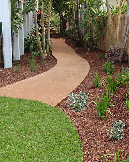 Deco garden path meandering up side of house, edged with corten steel edging